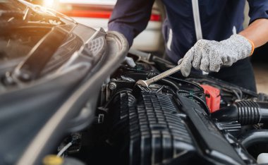 Otomobil tamircisi elleri araba motoru atölyesini tamir ediyor. .