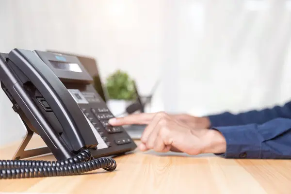 Call center staff man hand point to press the button number on the phone office desk , Communication support, call center and customer service help desk. for (call center) concept