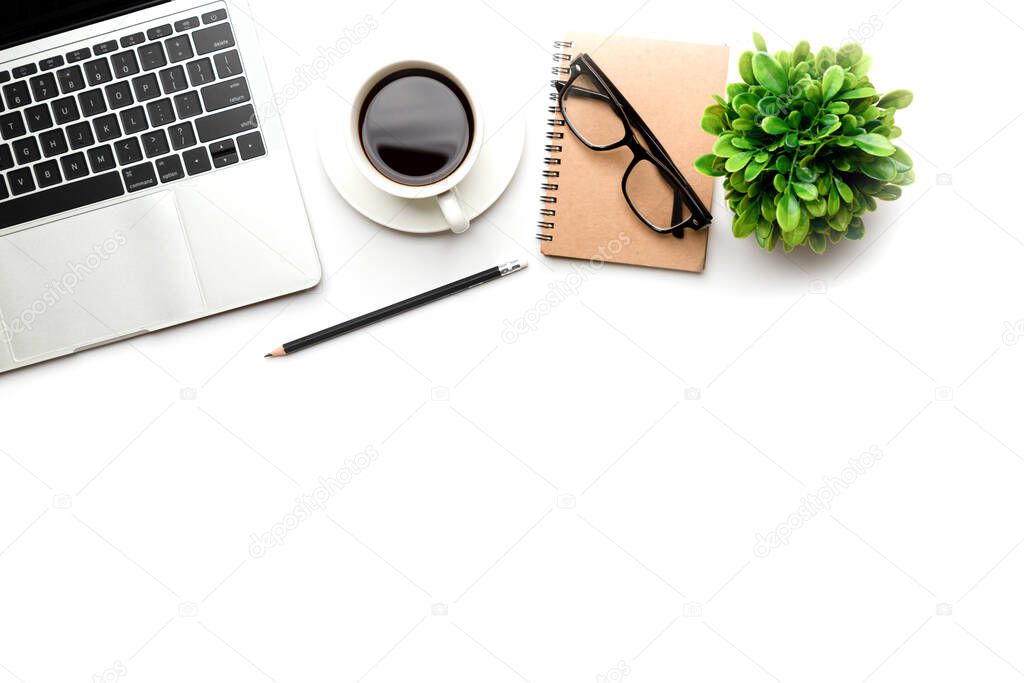 Flat lay, top view office table desk. Workspace with blank Laptop, office supplies, pencil, green leaf, and coffee cup on white background.