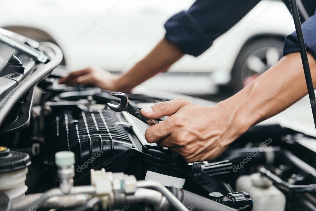 Automobile mechanic repairman hands repairing a car engine automotive workshop with a wrench, car service and maintenance,Repair service.