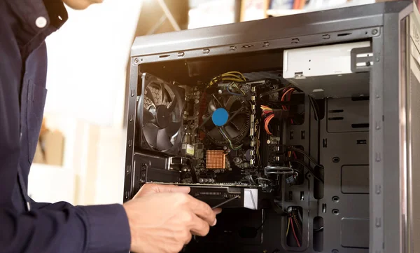 Technician with a screwdriver for fixing computers, computer har;