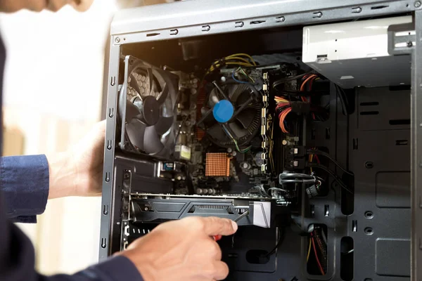 Technician with a screwdriver for fixing computers, computer har;