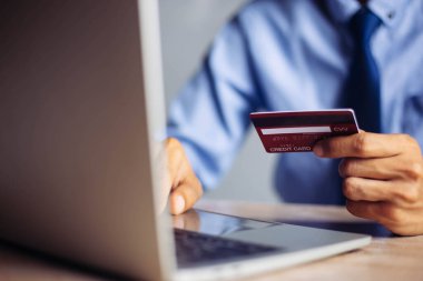 Online payment hands holding credit card and using laptop. Online shopping concept.