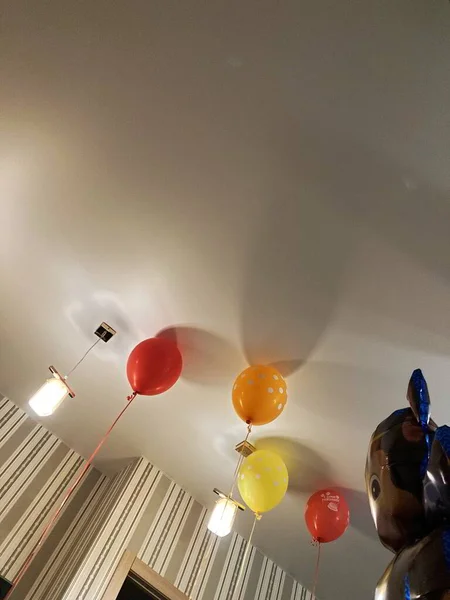 Dairede bir sürü renkli balon uçuyor.