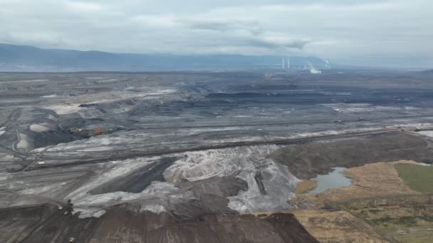 Brown coal opencast mine giant Vrsany, aerial video shot view, open pit lignite heavy quarry, mining power plants burn energy energetics, dumpers quarrying extractive, extraction landscape devastation — Stock Video