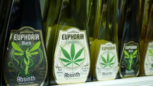 PRAGUE, CZECH REPUBLIC, SEPTEMBER 20, 2021: Cannabis alcohol absinth bottle energy drink liquor booze natural green shop store Prague euphoria, packaged hemp cannabidiol CBD alcoholic seeds — Stock Video