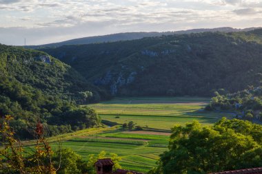 Hırvatistan 'ın eski Buzet kasabasından çayırların ve dağların manzarası