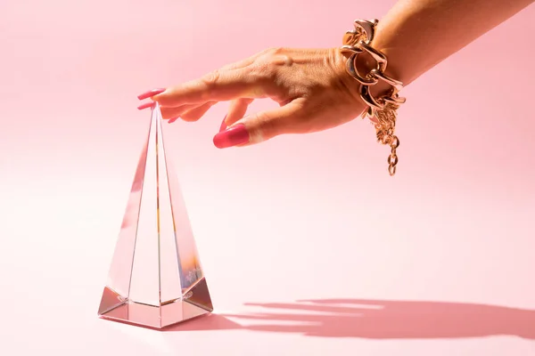 Woman Hand Golden Bracelet Touching Glass Pyramid Prism Pink Background — Foto de Stock