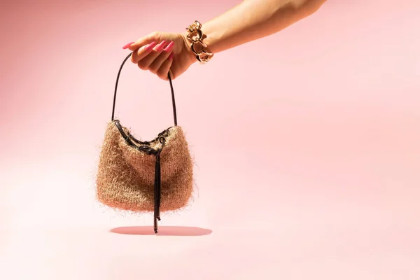 Female Hand Golden Bracelet Holding Little Bag Isolated Pink Background — Foto de Stock