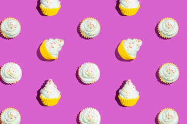 Colorful cupcake pattern on vibrant violet background. Creative minimal summer flat lay.