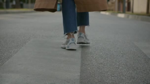 No face back view shot of woman walking on street — стоковое видео