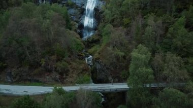 Stunning drone shot of cyclists on epic bridge