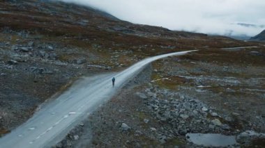 Following flying shot of cyclist exploring on road