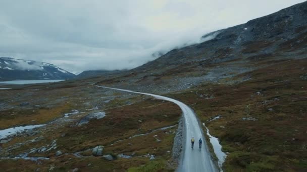 Epic flying drone shot of young cyclists riding — Vídeos de Stock