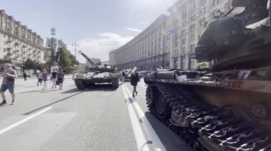 Khreschatyk street, exposition of captured, destroyed and burnt russian military equipment, artillery and tanks. Passers by look at war crimes proof. Independence day. KYIV, UKRAINE - 24 AUGUST 2022
