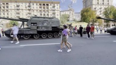 Khreschatyk street, exposition of captured, destroyed and burnt russian military equipment, artillery and tanks. Passers by look at war crimes proof. Independence day. KYIV, UKRAINE - 24 AUGUST 2022