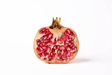 Beyaz zemin üzerinde yarı doğal nar meyvesi.