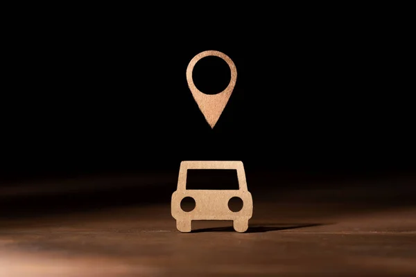 Cardboard representation of a car with the symbol of position on the map. Real time location and localization of vehicles