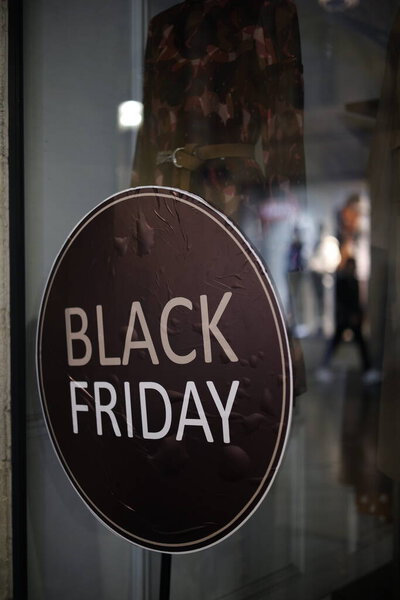 The inscription "Black Friday" on the shop window. An evening of calm on the eve of big sales in retail chains. The concept of highlighting the traditional signs of marketing activities.