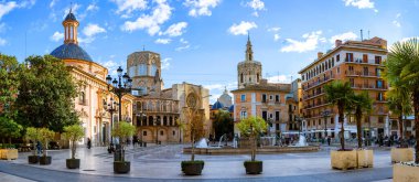 Evening panoramic view of Square of Saint Mary or Virgens square with Valencia Cathedral Temple, Basilica de la nuestra senora de los desamparados and the rio tura fountain in old town Valencia Spain clipart