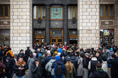 KYIV, UKRAINE - APR 20, 2022: A crowd of people standing in line at the Head Post Office for a stamp Russian warship go F..k, dedicated to the defeat of flagship Ru Black Sea fleet, the cruiser MOSCOW