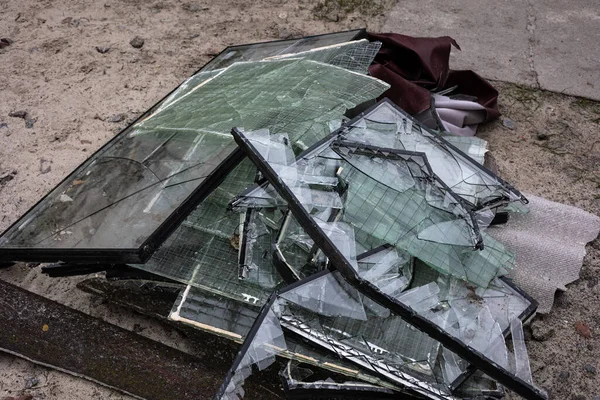 Piles of broken glass from windows from the apartment buildings were was knocked out by the blast wave as a result of by the Kalibr cruise missile airstrike at the 17 March of the full-scale Russian invasion of Ukraine