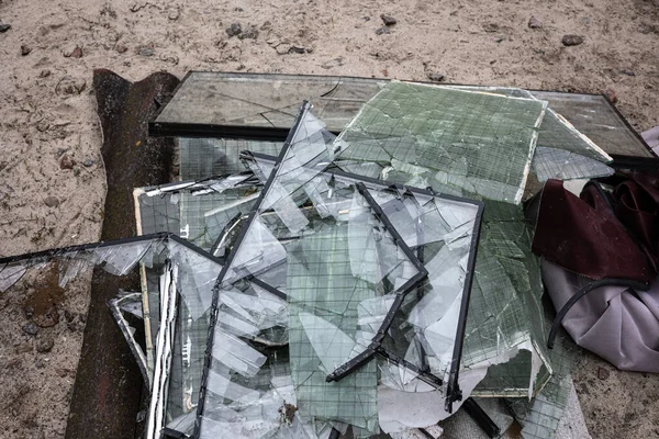 Piles of broken glass from windows from the apartment buildings were was knocked out by the blast wave as a result of by the Kalibr cruise missile airstrike at the 17 March of the full-scale Russian invasion of Ukraine