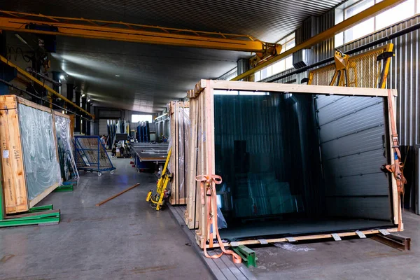 Factory for the production of double-glazed windows made of sheet glass. Sheet glass in pallets near the sheet glass cutting line.