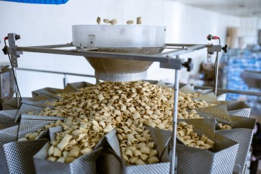 sorting and packing line of stuffed breakfast cereal pillows at factory conveyor for cereal snack production of flour products, technology production in food Industry