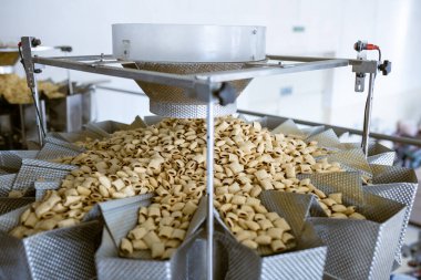 sorting and packing line of stuffed breakfast cereal pillows at factory conveyor for cereal snack production of flour products, technology production in food Industry