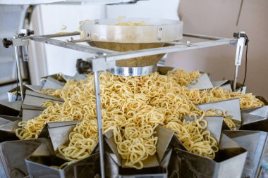 sorting and packing line of snack onion ring at factory conveyor for cereal snack production of flour products, technology production in food Industry