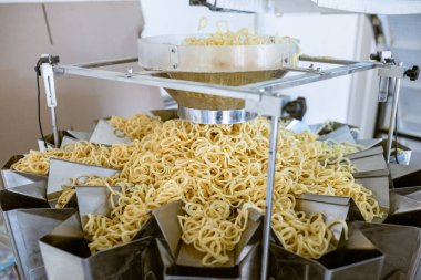 sorting and packing line of snack onion ring at factory conveyor for cereal snack production of flour products, technology production in food Industry