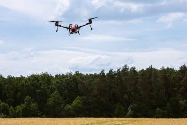 A modern solution in agricultural. Use of robotic systems with agriculture spraying drone fly to sprayed spraying chemical from insects - insecticides, fungicides, acaricide, or herbicides from weeds.