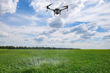A modern solution in agricultural. Use of robotic systems with agriculture spraying drone fly to sprayed spraying chemical from insects - insecticides, fungicides, acaricide, or herbicides from weeds.