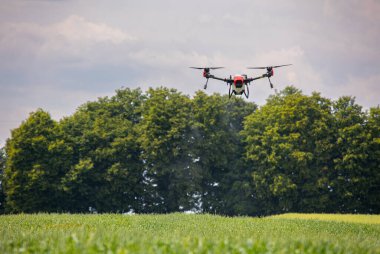A modern solution in agricultural. Use of robotic systems with agriculture spraying drone fly to sprayed spraying chemical from insects - insecticides, fungicides, acaricide, or herbicides from weeds.