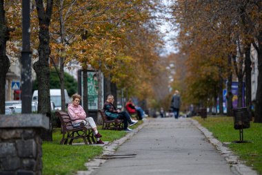 Kyiv, Ukrayna - OCT 01, 2022: İnsanlar, vatandaşlar ve konuklar, başkentin tarihi merkezinde sermaye gezintisinde sıcak bir sonbahar haftasonu geçiriyorlar ve alışverişe çıkıyorlar. Büyük bir şehirde günlük bir sokak hayatı.