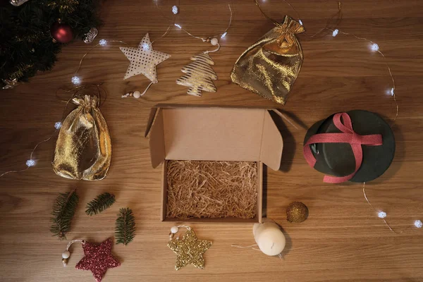 Mockup of a Christmas cardboard box on a wooden background — Stock Photo, Image