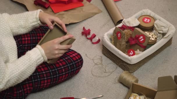 El primer plano de las manos de una mujer prepara el calendario de adviento — Vídeo de stock