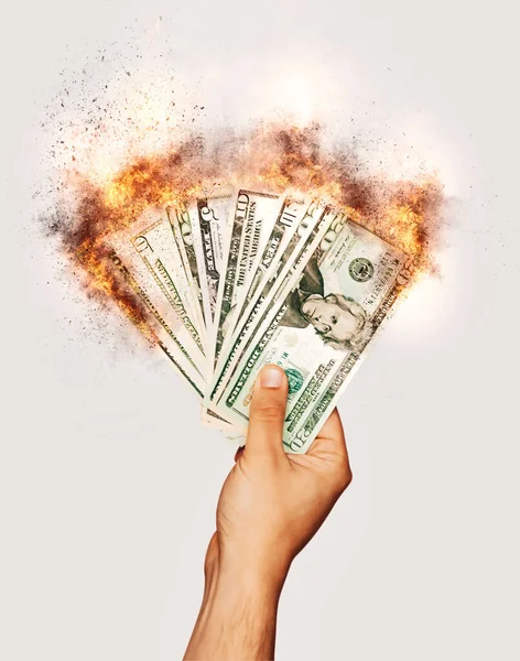 Burning dollar, money banknotes. Global economy. Burning dollar banknotes in man's hand.