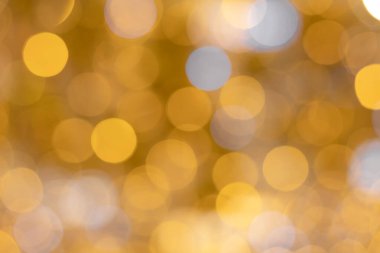 Parlak, parlak sarı ve beyaz bokeh renklerinin arkaplan görüntüsü. Optik yansıtma efekti