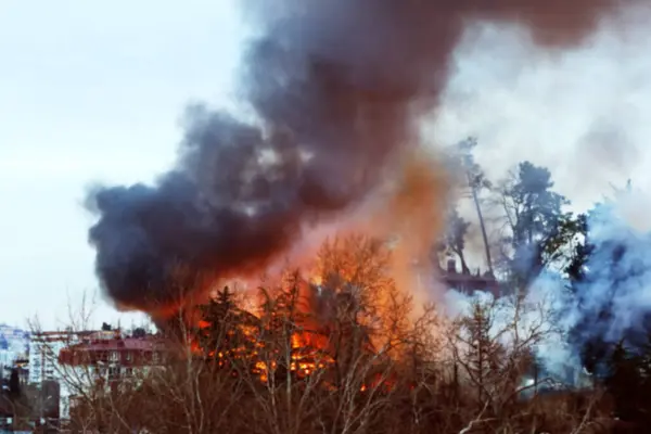 Strong house fire, a fire and black column of smoke. Blurred image