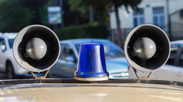 Megaphone on roof of the car. Signal police lamp. Retro style