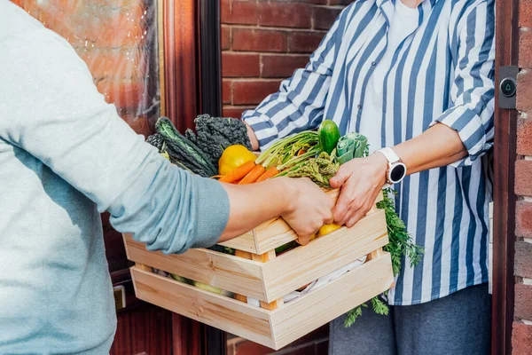 Home fresh food delivery. Woman taking wooden box with vegetables and fruits. Support local farmer food production . New Start of a healthy life, weight loss concept. Online food order. Recipe box — Stock Photo, Image