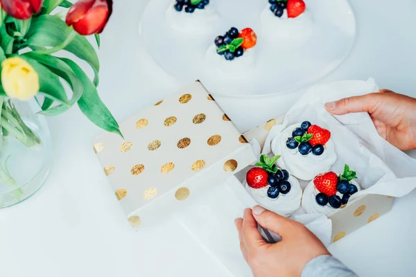 Frau Hält Geschenkbox Mit Pavlova Baiser Desserttorte Mit Frischen Erdbeeren — Stockfoto