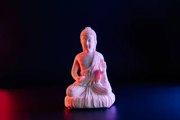 Decorative White Buddha Statuette Dark Background Red Blue Neon Light — Stockfoto