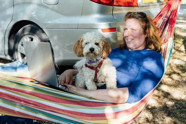 Adult Woman Working Laptop While Lying Hammock Her Cockapoo Puppy — Foto de Stock