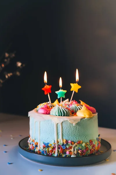Colorful Birthday Cake Sprinkles Burning Star Shaped Candles Dark Wall — Zdjęcie stockowe