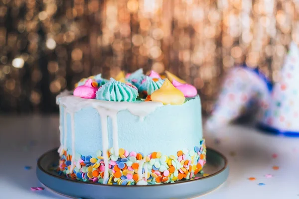 Colorful Birthday Cake Sprinkles Festive Caps Sparkling Gold Tinsel Background — Stockfoto