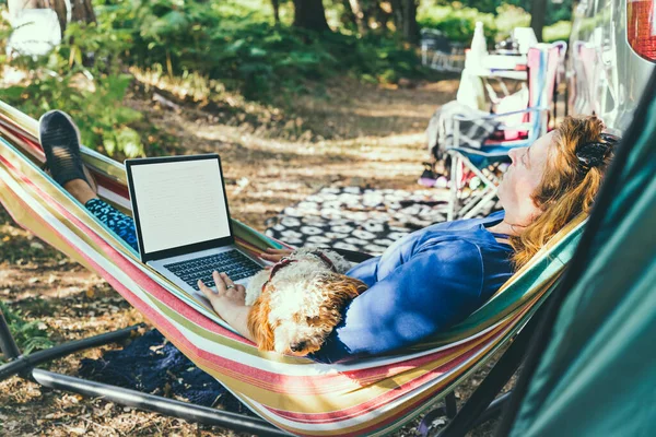 Adult Woman Working Laptop While Lying Hammock Her Cockapoo Puppy — Stockfoto