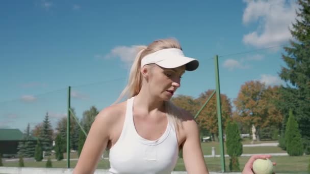 Pro tennis player hits the ball with a racket, practice game on the tennis court, young woman serving ball during tennis match, 4k slow motion. — Stock Video